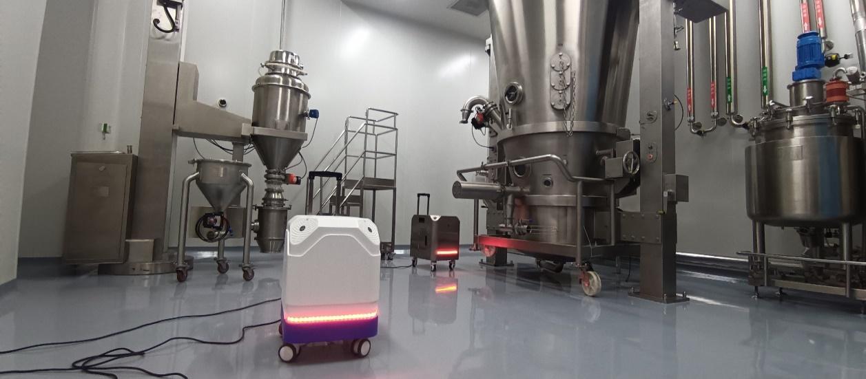 Portable disinfection equipment positioned beside stainless-steel production vessels